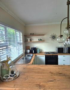 a kitchen with a wooden counter top and a sink at Fortune Cottage in Cape Town