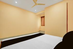 an empty room with a bed and a window at Spot ON Hotel Gyanvi Palace in Bhopal +23 photos