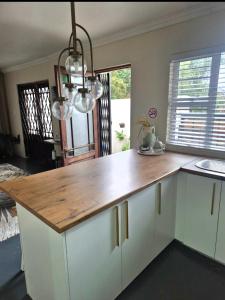 a kitchen with a wooden counter top in a room at Fortune Cottage in Cape Town