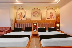 a bedroom with two beds and a couch at Hotel O Gomti Garden And Resort in Jhānsi +60 photos
