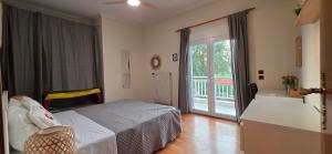 a bedroom with a bed and a sliding glass door at Full 3 Bedroom Apt-Summer Deal in Kerkini