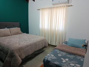 a bedroom with two beds and a window at Turquesa in Hernandarias