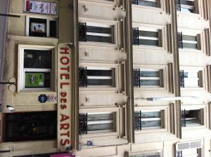 a building with a sign for a hotel at Hotel Des Arts in Paris +26 photos