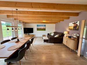 a living room with a table and a couch at Haus Muhblick in Schmallenberg