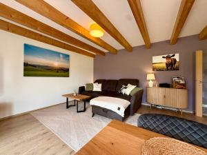 a living room with a couch and a table at Haus Muhblick in Schmallenberg