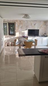 a kitchen with a table and chairs in a room at guesthouseminturnoit Lucia Sparagna in Minturno