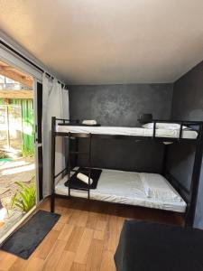 a bedroom with two bunk beds in a room at Container Hospedaria Paraty in Paraty