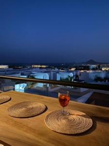 a glass of wine sitting on top of a table at Sunset view Penthouse 302 in Cabo San Lucas