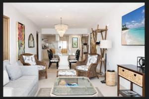 a living room with a couch and a table at Sunset view Penthouse 302 in Cabo San Lucas