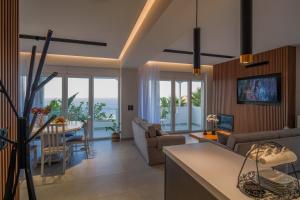 a kitchen and living room with a view of the ocean at Blue Vedere in Agia Pelagia