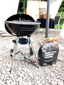 a charcoal grill with a bag of chips next to it at Buttys place in Abergavenny +41 photos