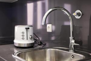 a toaster sitting on top of a kitchen sink at Dina Beach House in Nazaré +51 photos