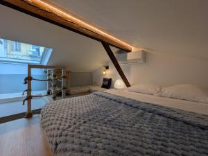 a bedroom with a large bed and a large window at Dieu Bé Nice in Nice