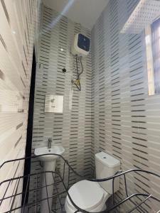 a bathroom with a sink and a toilet at Tameeza stays in Sangotedo