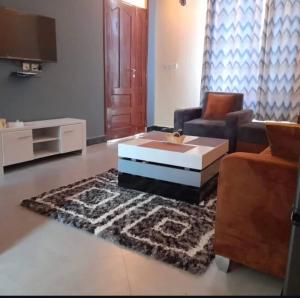 a living room with a couch and a coffee table at Migzhome in Dodoma