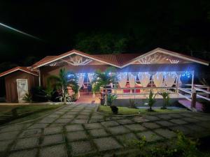 a house lit up at night with blue lights at Royal Escape - 1 in Anse La Raye +115 photos