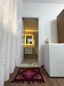 a bathroom with a white refrigerator and a rug at Home Lin in Lin +19 photos