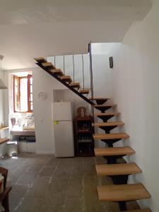 a spiral staircase in a room with a refrigerator at Casetta - Appartement dans maisonnette rustique in Cognocoli-Monticchi