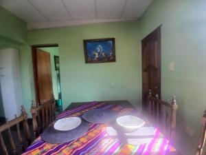 a bedroom with a bed with two white plates on it at Hospedaje Wara in Lozano +5 photos