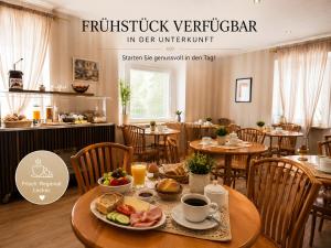 a restaurant with a table with food on it at Hotel Mainbrücke in Kitzingen +5 photos