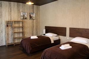 a bedroom with two beds with towels on them at Hotel Eden Mestia in Mestia