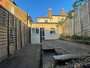 an empty parking lot in front of a house at Full House - Croydon centre in Croydon