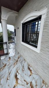 a building with a marble floor with a window at Angevita City1 in Edéa