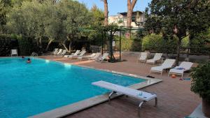 a swimming pool with lounge chairs at Capri Coral Home in Anacapri