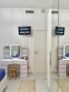 a bathroom with two mirrors and a sink at Perla Azzurra in Savona