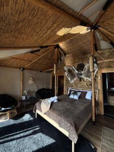 a bedroom with a bed in a tent at Lakajų Resort in Molėtai