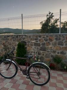 a bike parked in front of a stone wall at Home Lin in Lin