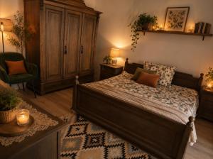 a bedroom with a bed and a chair and a cabinet at Levendula udvarház in Sopron