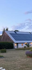 a barn with a lot of solar panels on the roof at Gästis in Borrby
