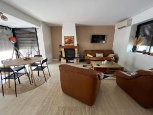 a living room with two couches and a table at Le Sevirqueno in Bougarber