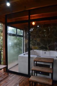 a room with a tub and a table and benches at Cabaña sueño real in Mazamitla