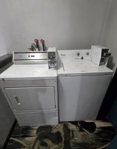 a white stove and a dishwasher in a room at Super 8 by Wyndham O'Fallon MO/St. Louis Area in O'Fallon +7 photos
