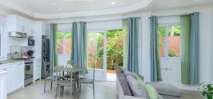 a kitchen and living room with a table and a couch at Agape Suites-Room 2-Ground Floor in Soufrière