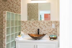 a bathroom with a bowl sink and a mirror at Agape Suites-Room 2-Ground Floor in Soufrière +14 photos