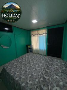 a bedroom with a bed in a green room at Holiday San Jorge in Fortuna +5 photos