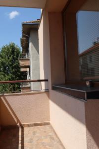 a balcony of a building with a window at Central apartments Pleven in Pleven