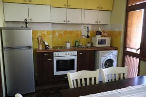 a kitchen with a white refrigerator and a dishwasher at Central apartments Pleven in Pleven