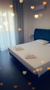 a bedroom with a bed with two towels on it at TRIUMPH rooms and apartment in Vlorë