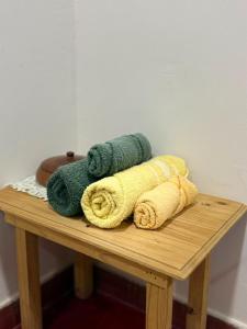 a pile of towels sitting on a wooden table at Casa familiar in Corrientes