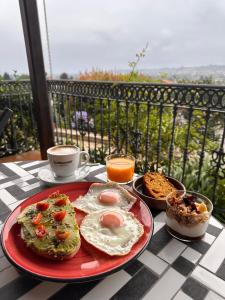 a plate of breakfast food on a table with a view at El Mirador de Deva in Deva