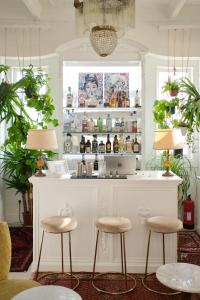 a kitchen with a bar with two stools in front of it at Casal Santa Virginia in Sintra