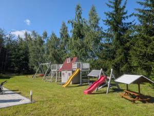 a group of playground equipment in a park at Chill House Sedranki in Olecko