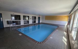a large swimming pool in a building at Super 8 by Wyndham O'Fallon MO/St. Louis Area in O'Fallon