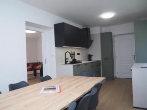 a kitchen and a wooden table in a room at Popelucha in Lomnice nad Popelkou