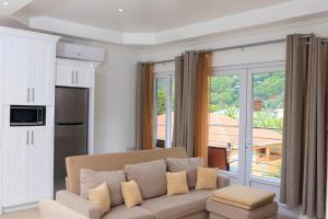 a living room with a couch and a large window at Agape Suites-Room 3- 1st Floor in Soufrière