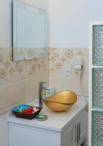 a bathroom with a sink and a bowl on a counter at Agape Suites-Room 3- 1st Floor in Soufrière +42 photos
